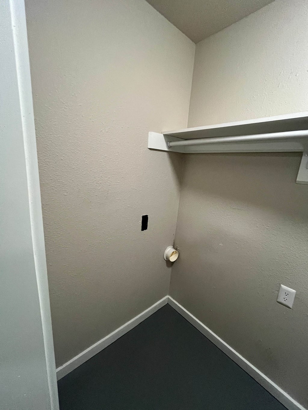 an empty room with a closet and a white door