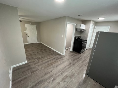 A kitchen area with a refrigerator, a dishwasher, and a washing machine.