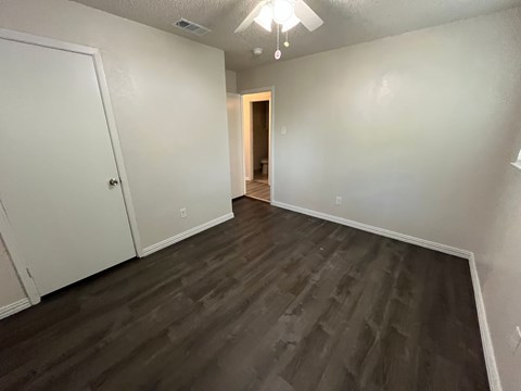 A room with a wooden floor and white walls.