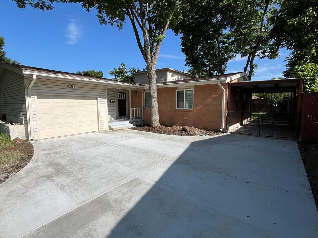 a large driveway in front of a house with a garage door