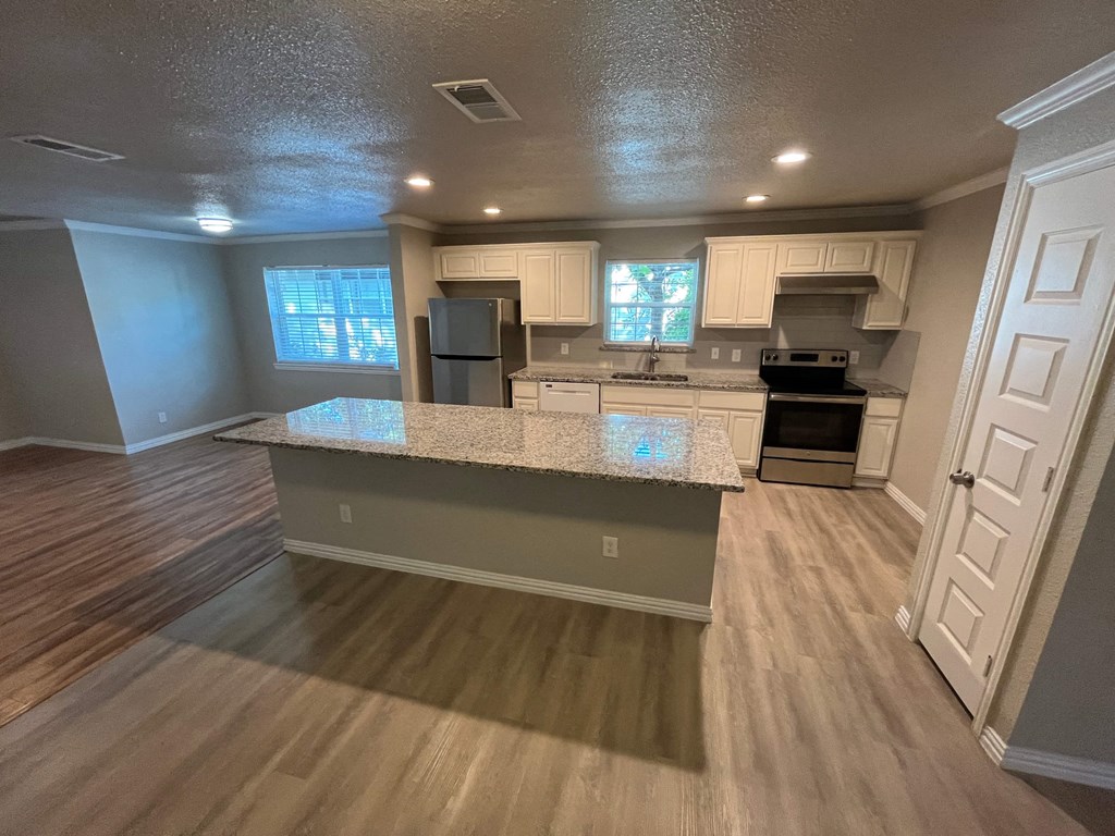 an open kitchen with a granite counter top