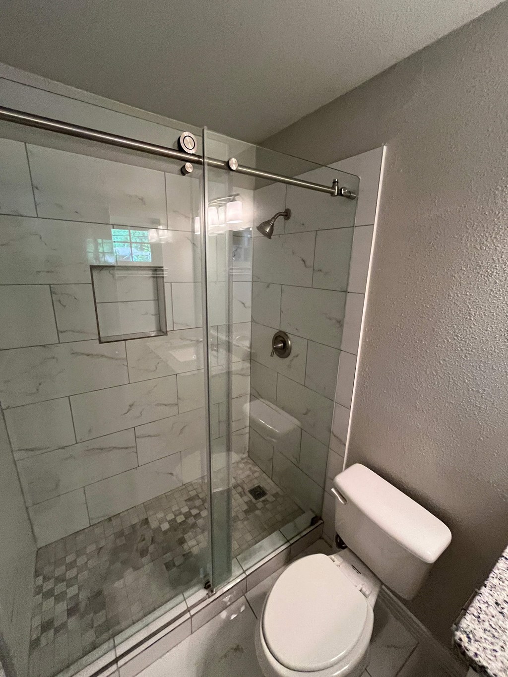 a small bathroom with a toilet and a shower