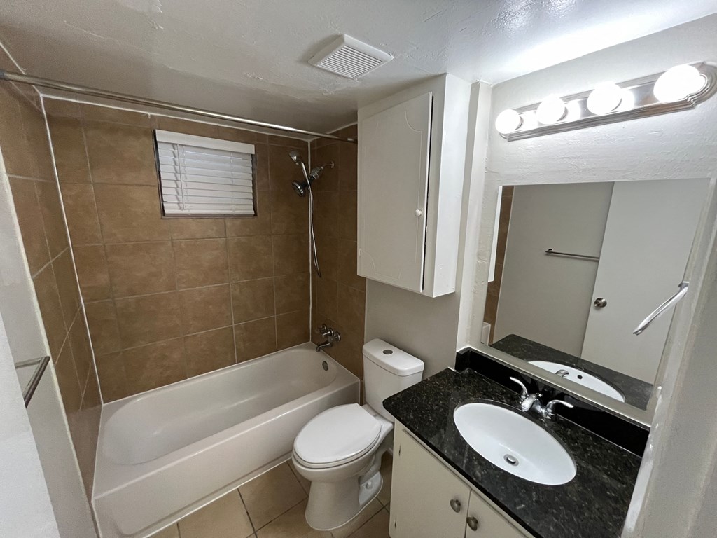 a bathroom with a sink toilet and a bath tub