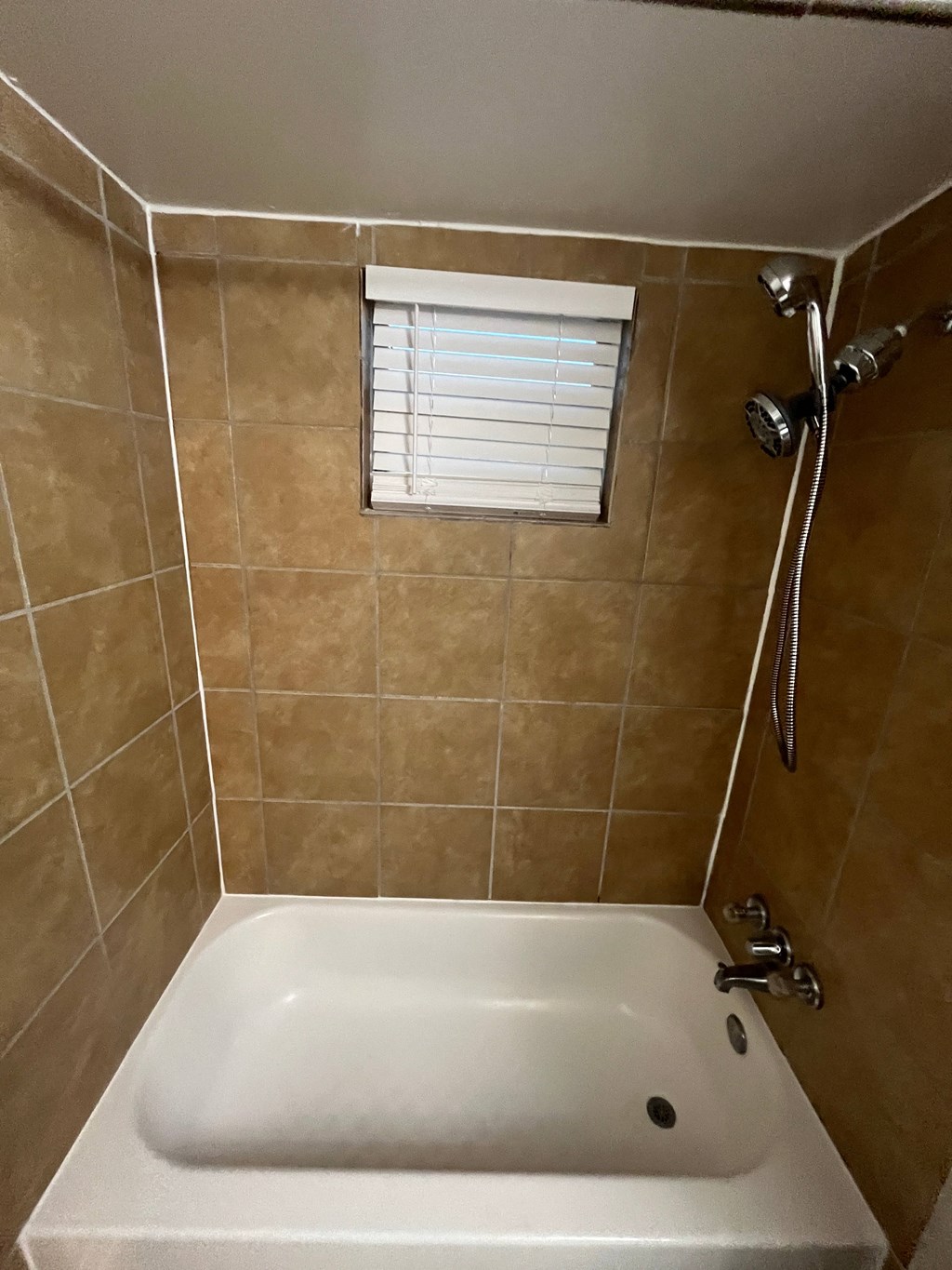 a small bathroom with a shower and a sink