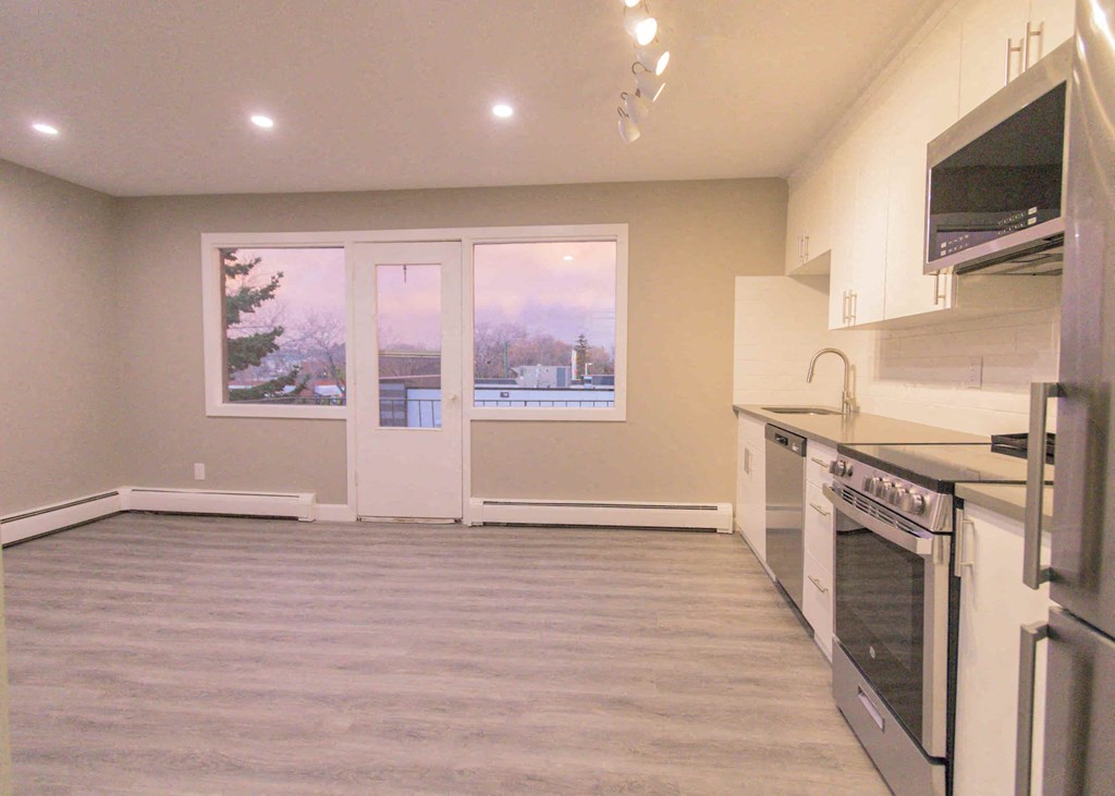 a kitchen with a stove top oven and a window