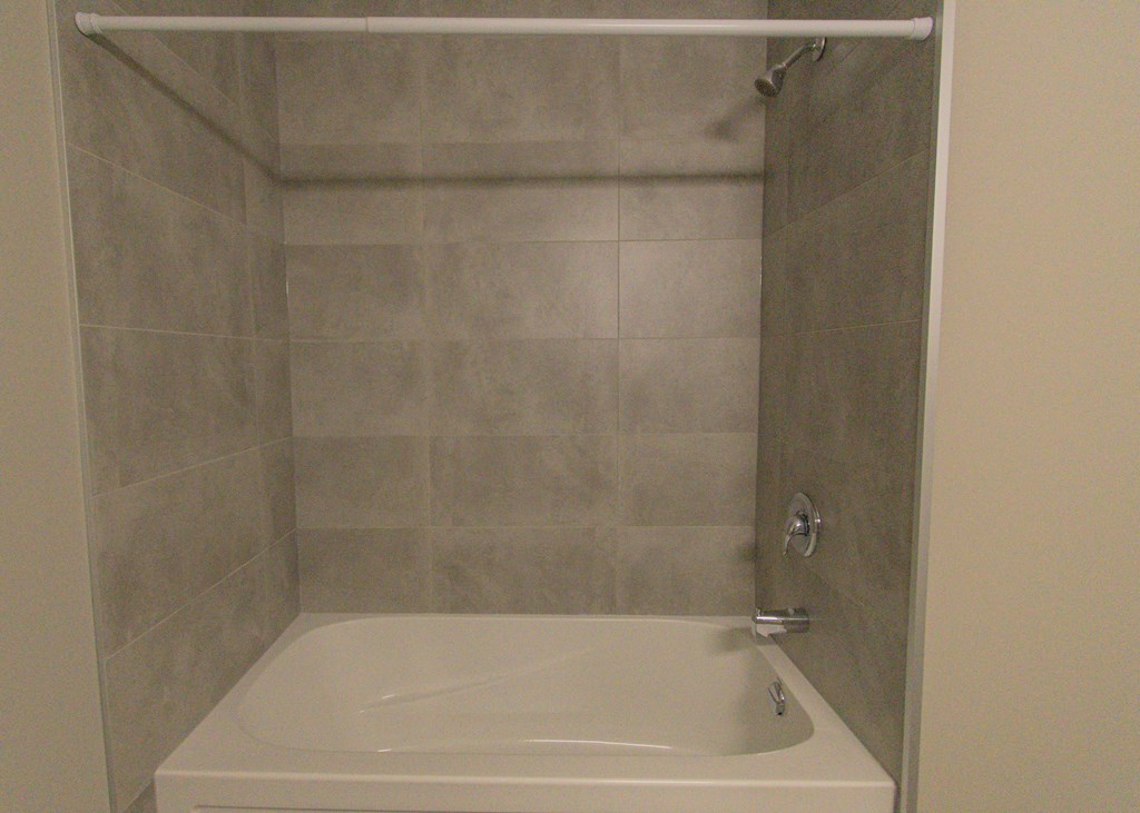 a small bathroom with a shower and a bath tub
