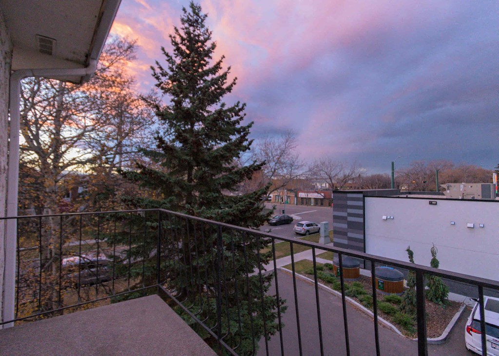 a view of a christmas tree from the balcony of a condo