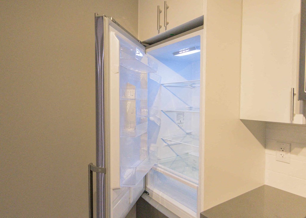 a refrigerator with its door open in a kitchen