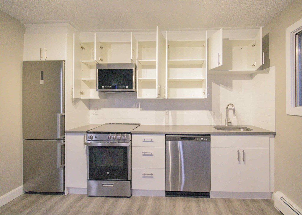 a kitchen with stainless steel appliances and white cabinets