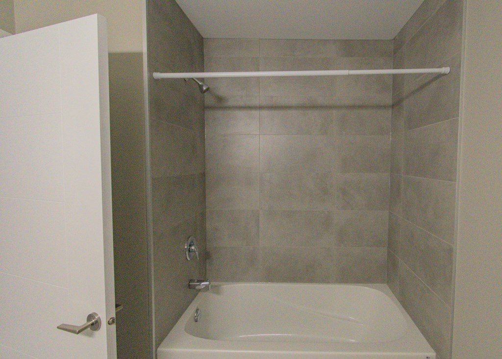 a small bathroom with a shower and a sink