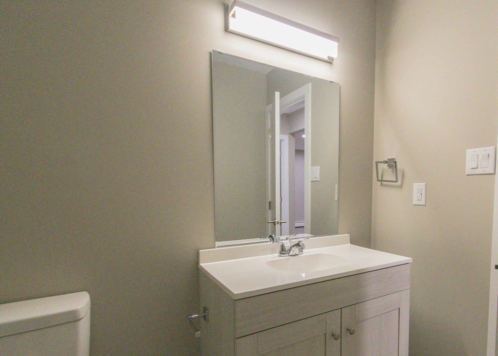 a small bathroom with a sink and a mirror