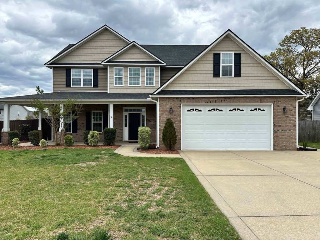a house with a white garage door and a lawn
