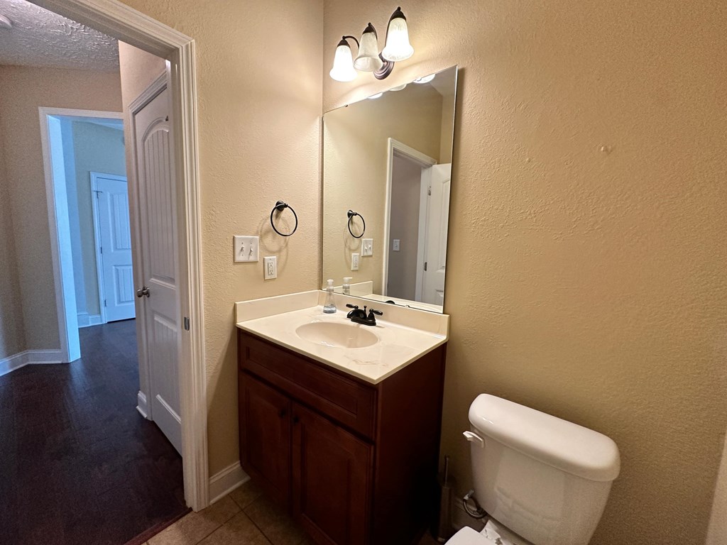 a bathroom with a toilet sink and a mirror