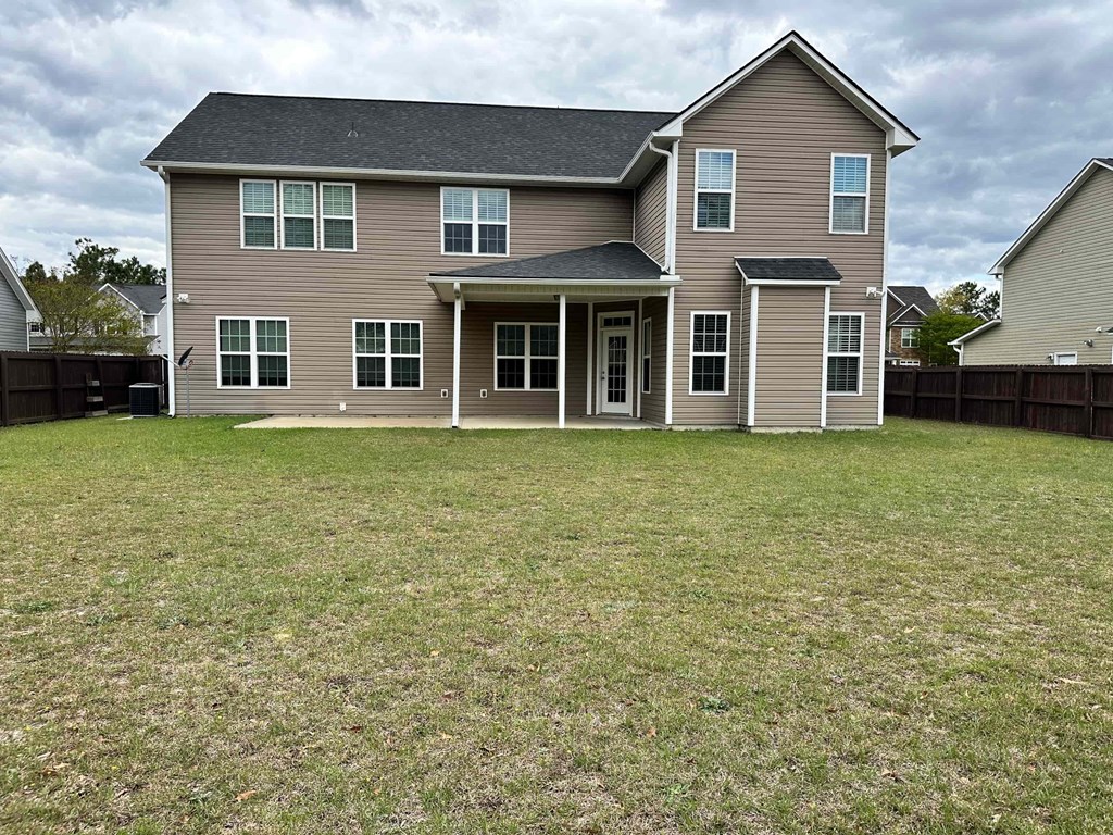a large house with a yard in front of it