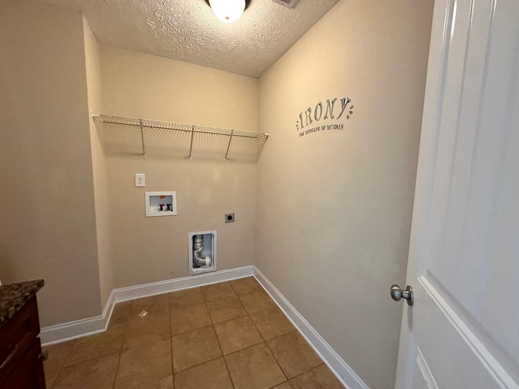 the entryway of a home with a closet and a wall with a hanging rack
