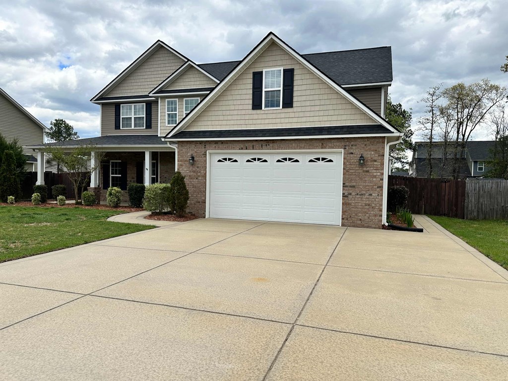 a house with a driveway and a white garage door