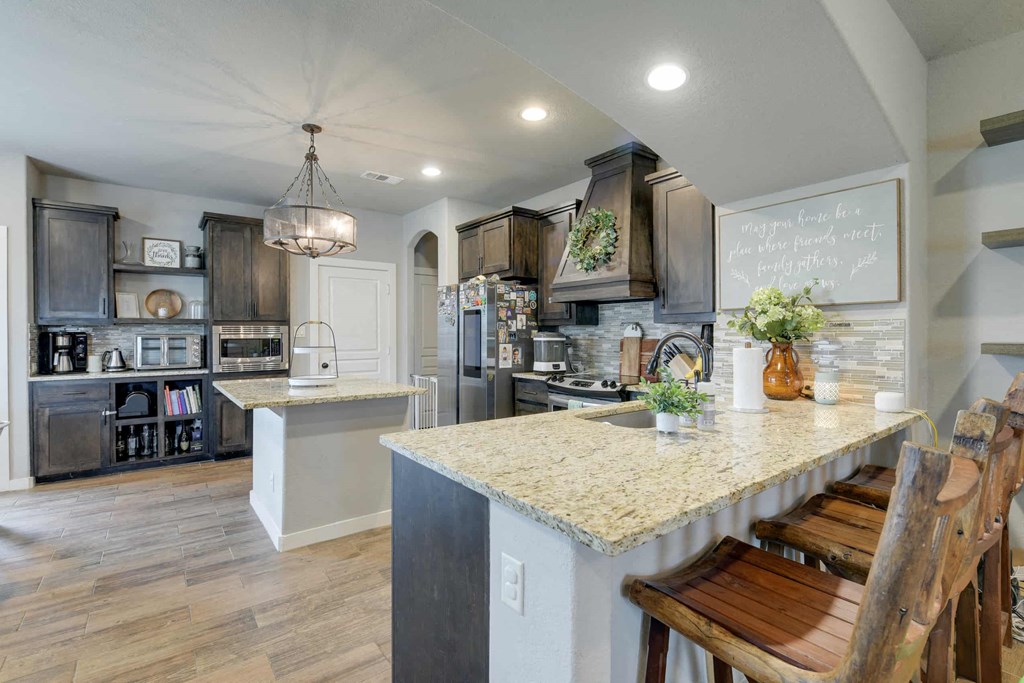 a kitchen with a marble counter top and a large island