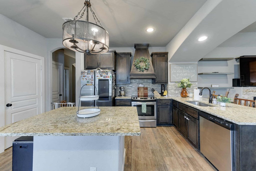 a kitchen with stainless steel appliances and granite counter tops