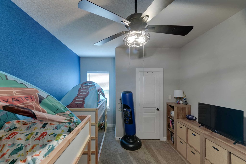 a bedroom with bunk beds and a ceiling fan
