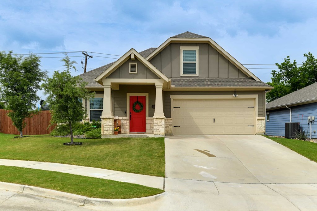 a house with a red door and a driveway