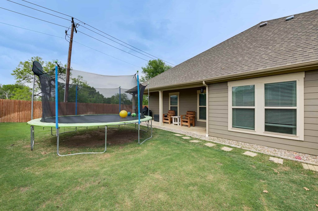 a trampoline in the backyard of a house