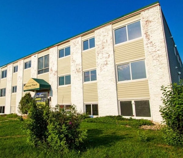 an old building with a green lawn in front of it