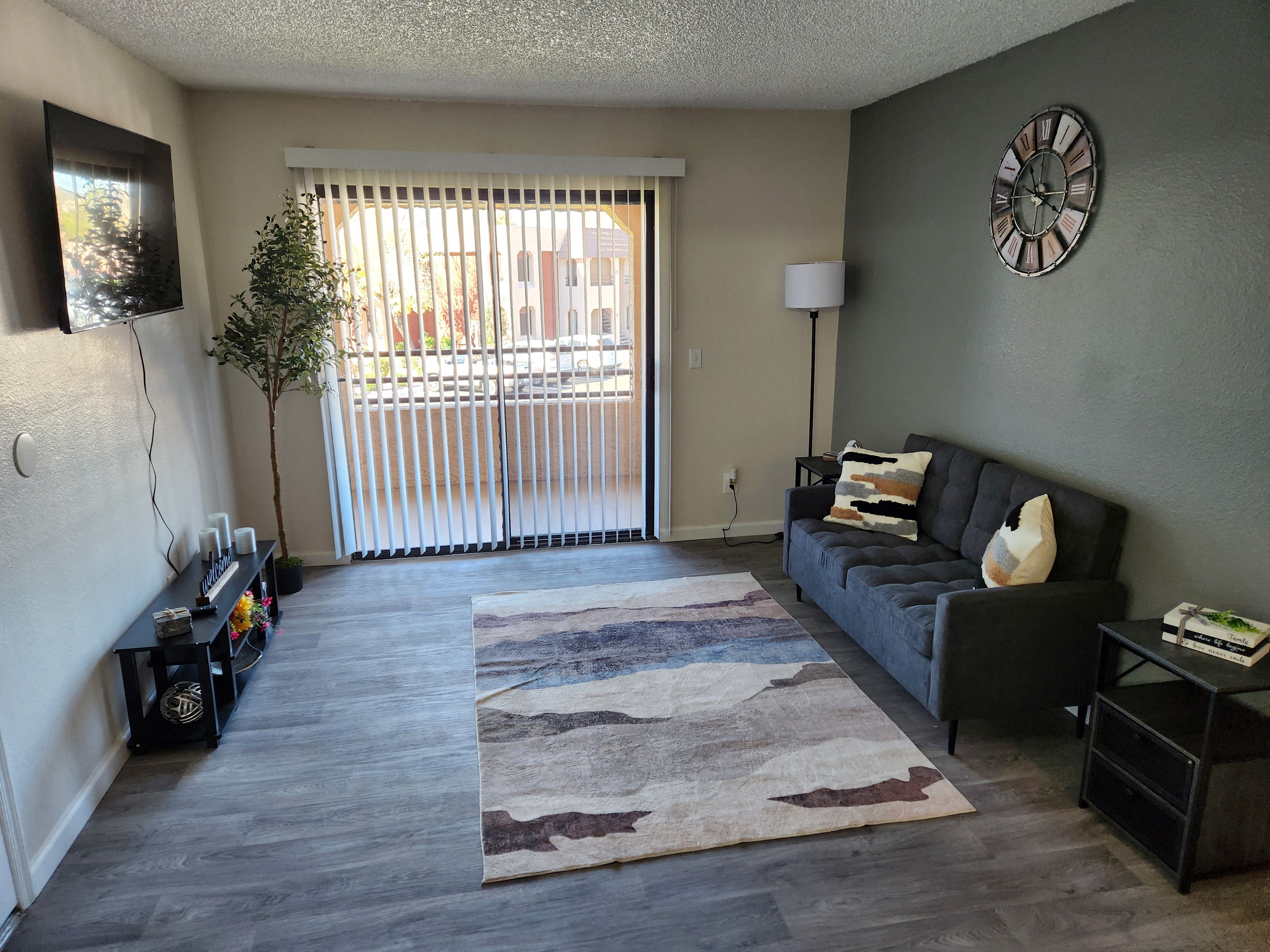 a living room with a couch and a sliding glass door