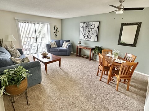 an open living room and dining room with a couch and a table