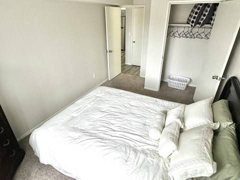 a small bedroom with a bed and a closet