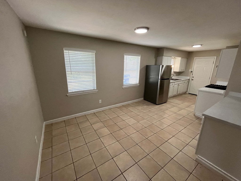 a kitchen with a refrigerator and a sink