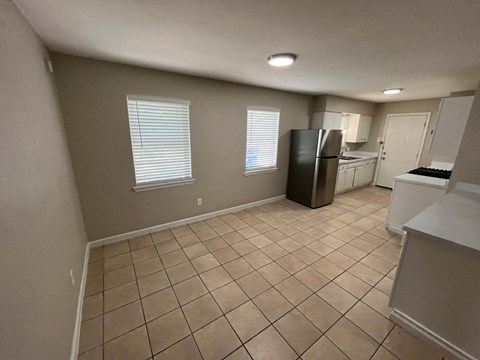 a kitchen with a refrigerator and a sink