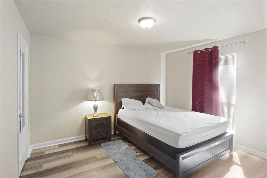 a bedroom with a bed and a night stand