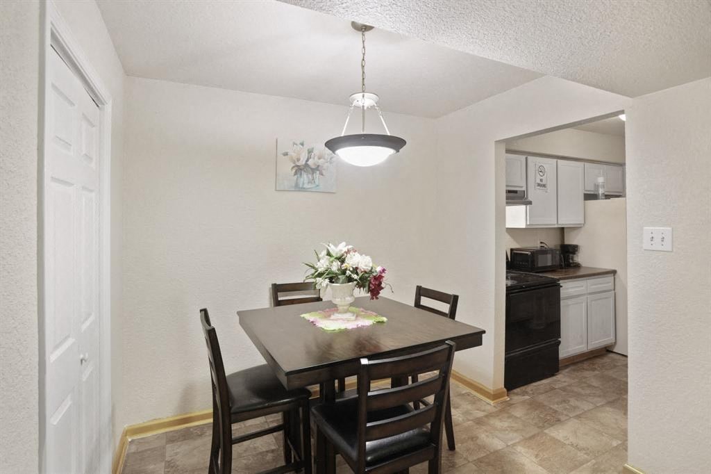 a dining room with a table and chairs