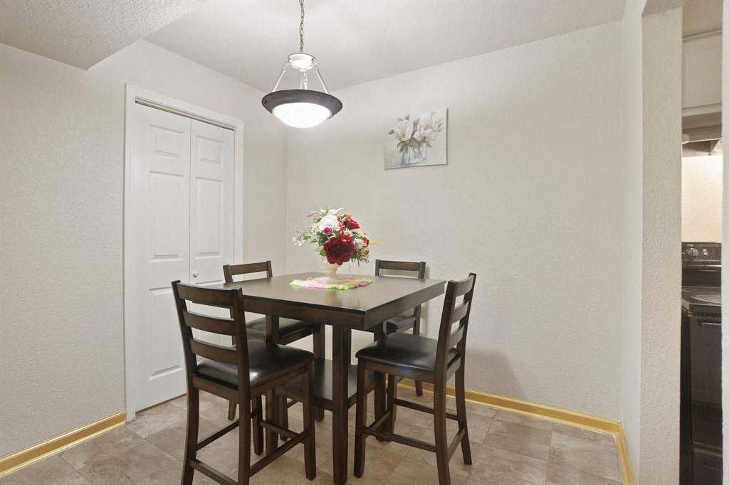 a dining room with a table and chairs