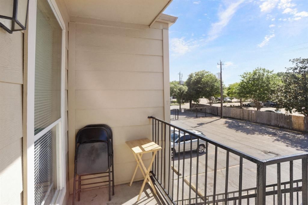 a balcony with a chair and a table on it