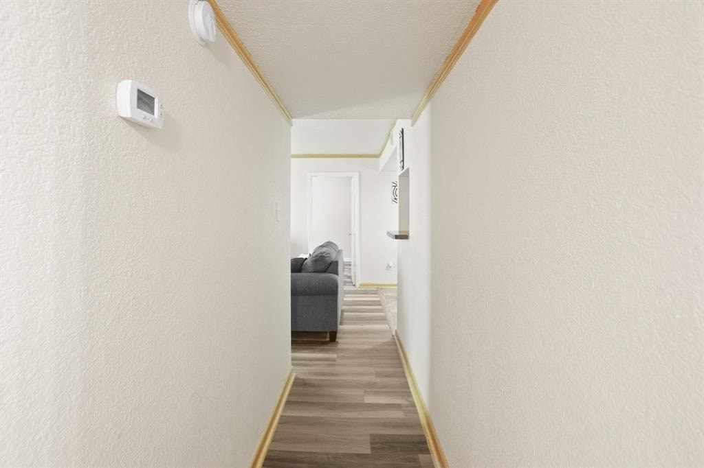 a hallway with a couch and a door to a living room
