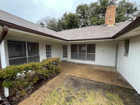 A house with a brown roof and a white exterior.