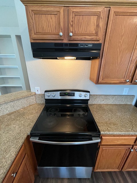 A black stove top oven with a silver pot on it.