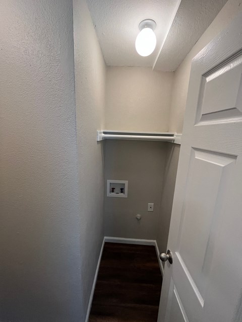 A white door is on the right side of a hallway.