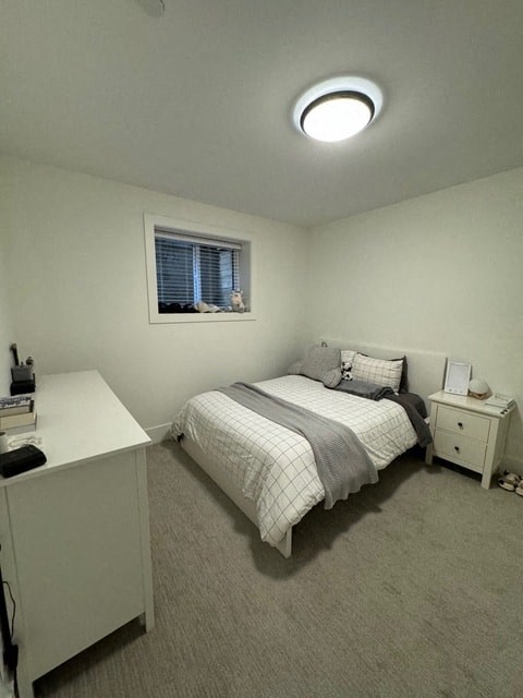 a small bedroom with a bed and a window