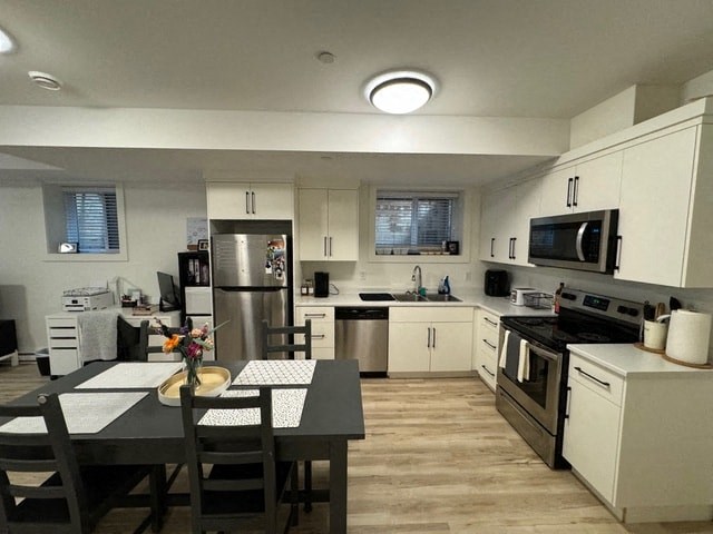 a large kitchen with a table and chairs