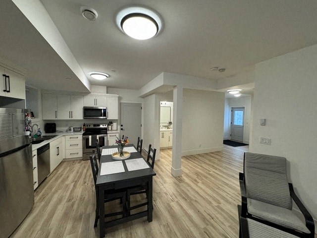 a kitchen and dining room with a table and chairs