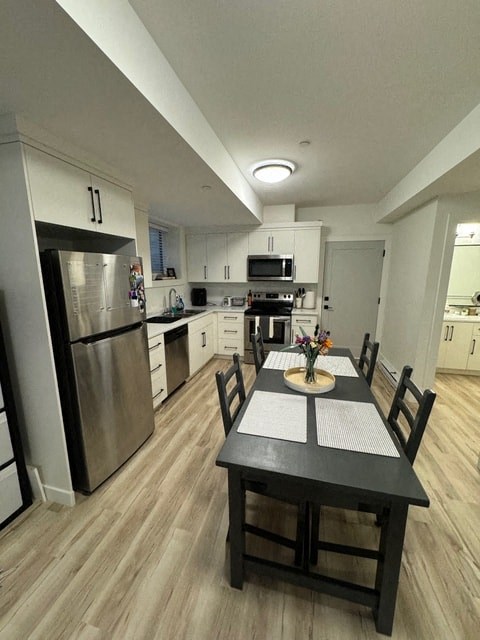 a kitchen and dining room with a table and chairs