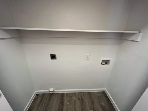 A room with a white ceiling and a wooden floor.