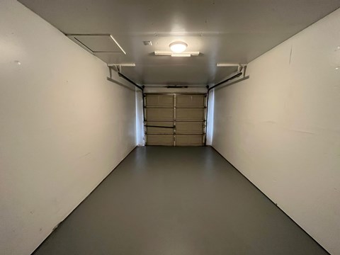 A long, narrow hallway with a light at the end.
