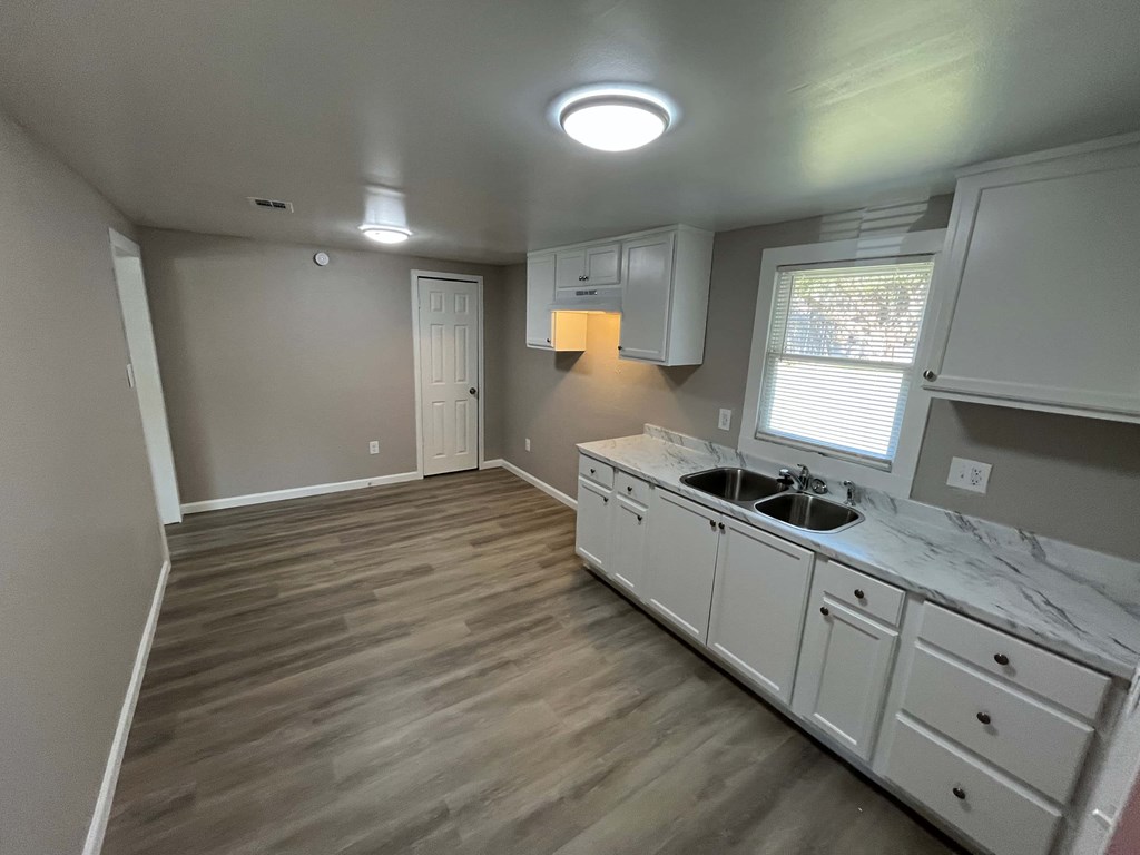 A kitchen with a sink and cabinets.