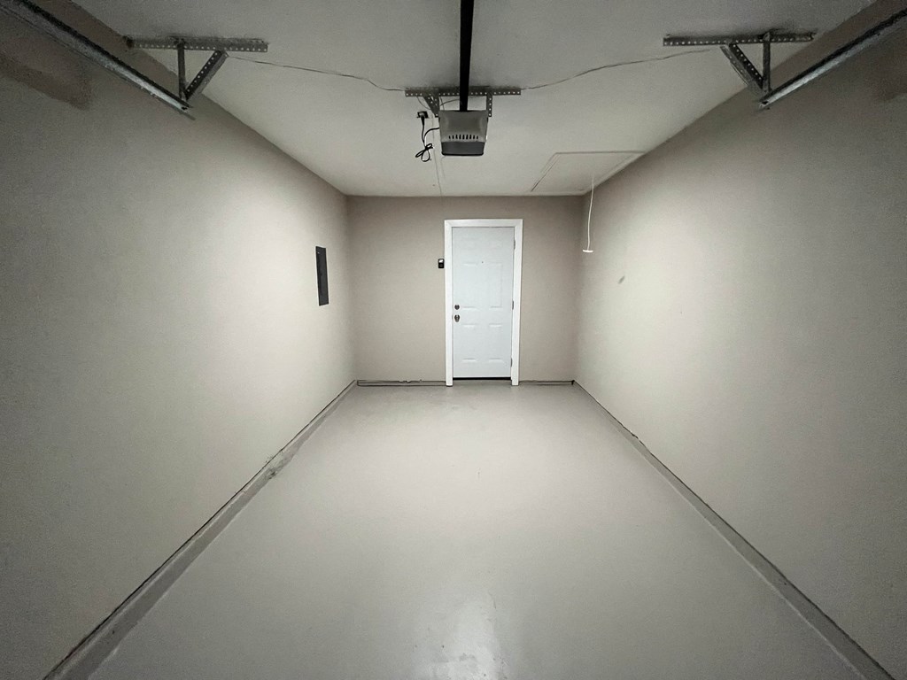 a white room with a door in the middle of it