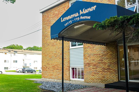 a blue awning on the side of a brick building