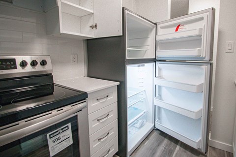 a kitchen with a stove refrigerator and