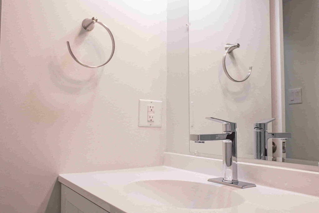 a bathroom with a sink and a mirror